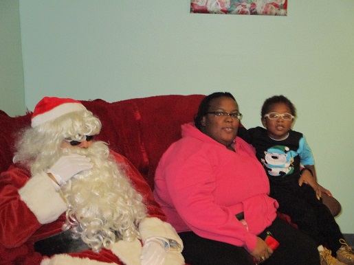 A mother and her son sitting with Santa